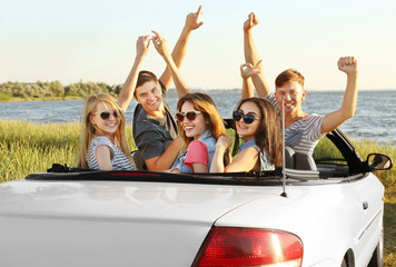 Happy friends in car
