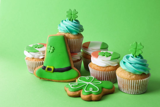Cupcakes and cookies on green background. Saint Patrics Day concept