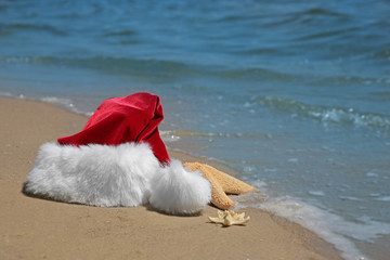 Santa hat with sea stars on beach