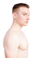 Fototapeta premium Handsome man on a white background with a naked torso in blue jeans