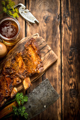 Pork ribs grilled with a meat hatchet and beer.