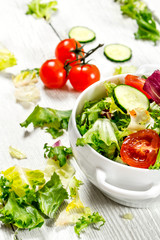 Salad of tomatoes and cucumbers with fresh greens.