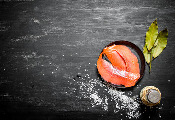 Thin slices of smoked salmon with salt.