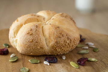 Freshly baked white bun on a wooden board