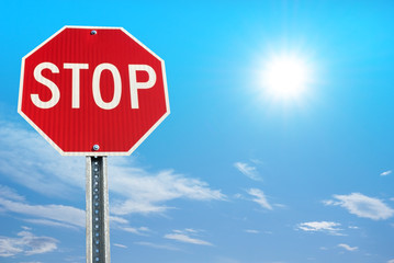 Stop sign on blue sky background