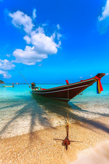 Fototapeta na wymiar Boat at the beach with Palm Shades