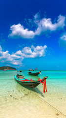 Boat on the beach with turquoise water.