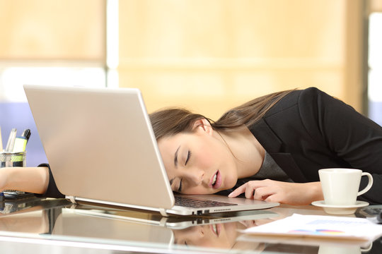 Overworked businesswoman sleeping at work