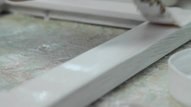 Girl paints a paint box of handmade