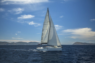Fototapeta na wymiar Sailing ship luxury yacht with white sails in the Aegean Sea.