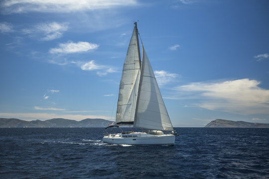 Sailing ship luxury yacht with white sails in the Aegean Sea.