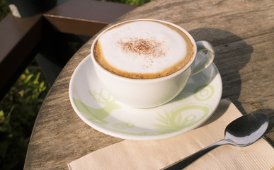 Hot coffee cup on wood table