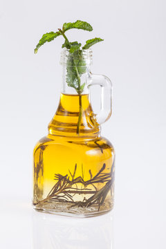 Glass bottle of premium virgin olive oil  on a white background