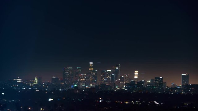 Time-lapse of downtown Los Angeles at night with planes circling 