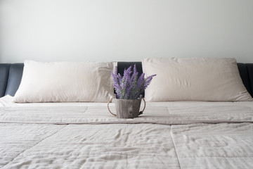 The bed with purple lavender flower on flower pot.