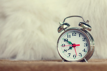 Vintage background with retro alarm clock on table