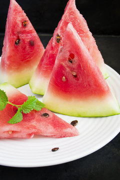 Slices of watermelon on a white plate