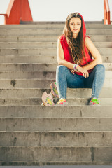 Skate girl on stairs with skateboard.