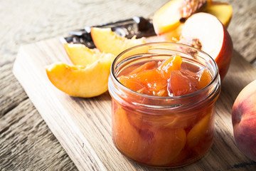 Homemade peach jam on  wooden table © istetiana