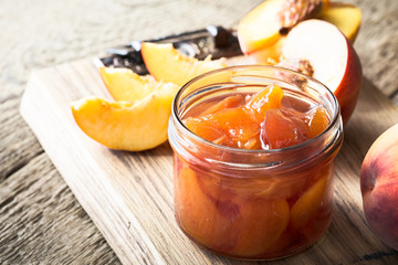 Homemade peach jam on  wooden table