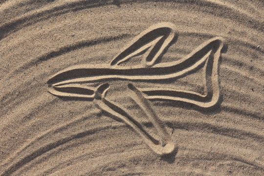 airplane draw on the sand in the beach
