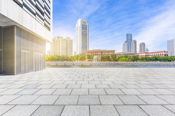 empty brick floor with city skyline background