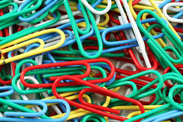 An extreme close up image of colored paper clips