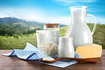 Dairy products on wooden table on mountain slopes
