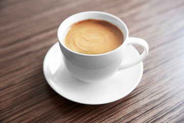 Fototapeta na wymiar Cup of coffee on wooden table