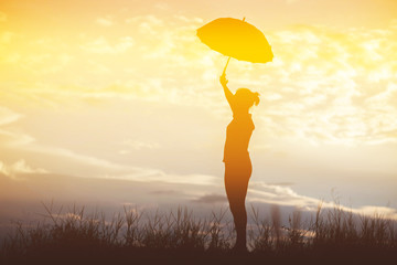 Umbrella woman and sunset silhouette