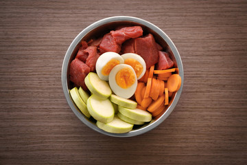 Healthy dog food on wooden background