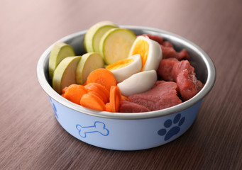 Healthy dog food on wooden background