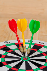 Dart arrow hitting in bullseye on dartboard