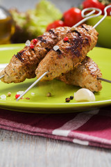 Barbecued kofta - kebeb with vegetables on a plate.