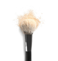 Make up brush and beige eye shadows on white background