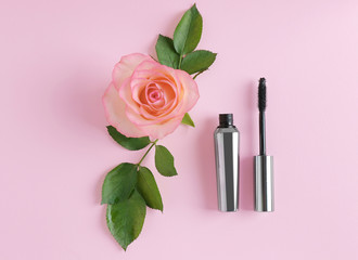 Mascara and flower on pink  background