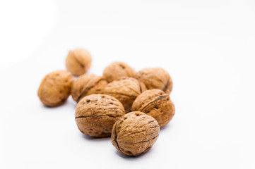 closeup of group of walnuts on white background