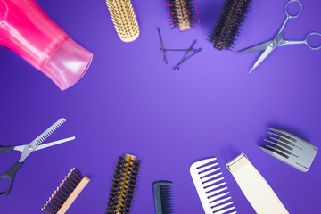 Hairdresser set with comb on top of purple background.