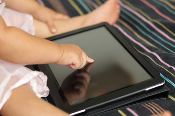 Baby cute hand using  touchscreen tablet PC