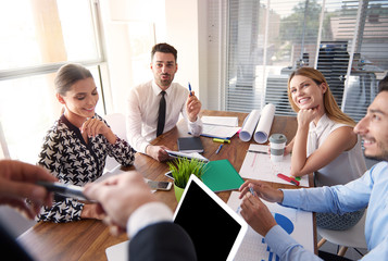 Cheerful office workers around the table.