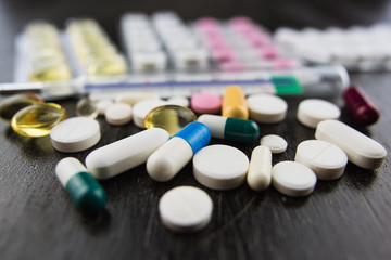 Closeup of pills and thermometer