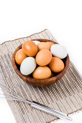 eggs in wooden bowl on white backgrond.
