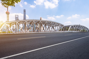 empty asphalt road with cityscape and skyline of Shanghai