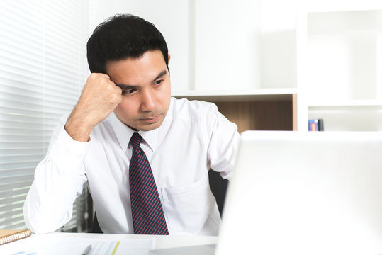 Asian businessman getting stressed (upset) at work