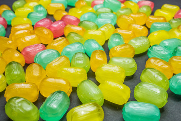 Mixed colorful fruit hard candies as background