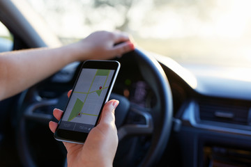 Woman in the car with mobile phone