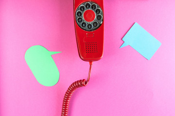 Vintage red phone and speech ballons