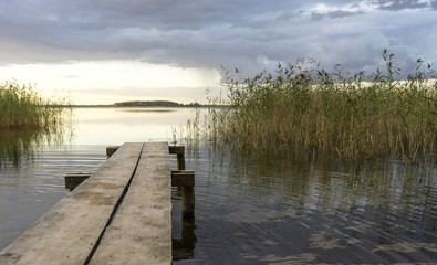 pier on the lake among the reeds