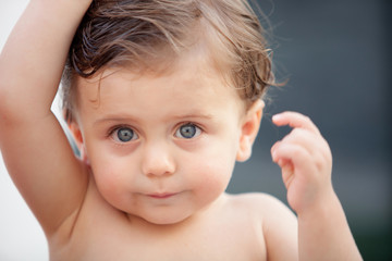 Beautiful baby outside with wet hair