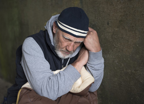 Mature man looking down to the floor with an upset and worried facial expression 